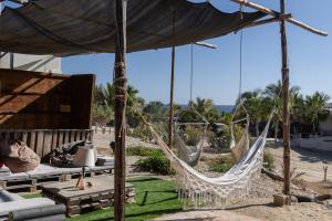 a resort with hammocks and a view of the ocean at The Baja Station in San José del Cabo