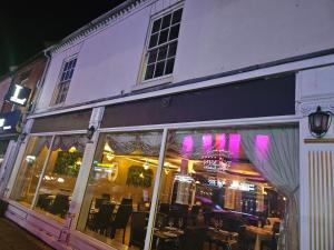 a store front with tables and chairs in a building at Northampton RoomKey in Northampton