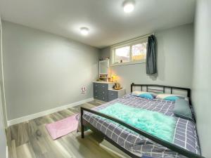 a bedroom with a bed and a window at Double room suite near Downtown in Calgary