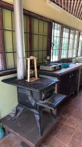 an old stove sitting in a room with windows at Quinta La Lomita in Turrialba