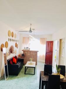 a living room with a couch and a table at HOST HOMES-SANDY LANE in Tacloban +40 photos