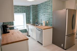 a kitchen with a stainless steel refrigerator and a sink at Luxury Penthouse -3 Blocks to Boardwalk, Outlets, & Casinos - Near AtlantiCare in Atlantic City +38 photos