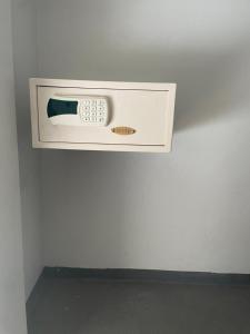 a microwave on a wall in a room at S4 HOTEL AGUAS CLARAS TorresReis2 in Brasilia +2 photos