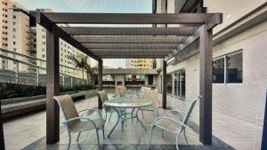 a patio with a table and chairs on a balcony at S4 HOTEL AGUAS CLARAS TorresReis2 in Brasilia