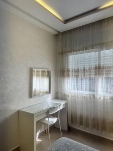 a home office with a desk and a window at Appartement élégant au cœur de Ain Hayani in Tangier