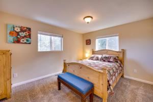 a bedroom with a wooden bed and a blue stool at Comforting Woodland Park Home with Fire Pit! in Woodland Park