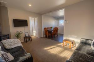 a living room with a couch and a table at Modernised Mackenzie with central location. in Twizel