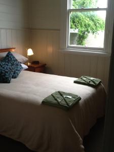 a bedroom with a bed with two towels on it at Royal Hotel Snake Valley in Snake Valley