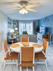 a living room with a table and chairs and a couch at Newly Renovated St Augustine Beach & Tennis Club 2bed 2bath Condo w Oceanview in Saint Augustine