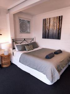 a bedroom with a large bed in a room at Lovely Private Studio Apartment in Tauranga