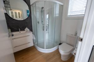 a bathroom with a shower and a toilet and a sink at “No.25”Stand alone guest studio unit in Twizel
