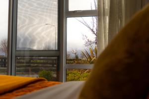 a window in a bedroom with a view of a view at “No.25”Stand alone guest studio unit in Twizel