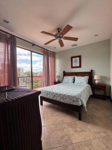 a bedroom with a bed and a ceiling fan at Monaco Condominiums, Jacó, Costa Rica - Luxury 3 Bedrooms in Jacó
