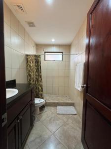 a bathroom with a toilet and a sink at Monaco Condominiums, Jacó, Costa Rica - Luxury 3 Bedrooms in Jacó