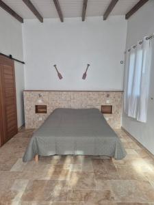 a bedroom with a bed in a white room at Chez didine in Terre-de-Haut