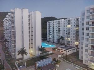 an aerial view of apartment buildings and a pool at happy summer in Girardot