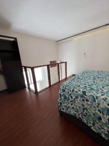 a bedroom with a bed and a staircase in it at Bonito Mini Departamento 9 in Puebla +6 photos