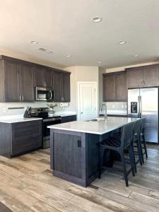 a kitchen with a large island in the middle at The Retreat - Hot Tub Fire Pit Boat Parking in Page +30 photos