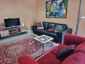 a living room with a couch and a tv at Barn at Ambrosia in Katikati