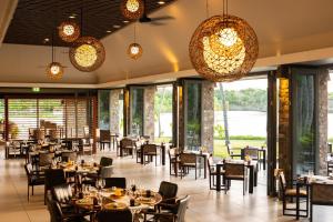 a restaurant with tables and chairs and lights at InterContinental Fiji Golf Resort & Spa by IHG in Natadola