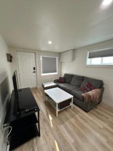 a living room with a couch and a table at Cozy Private Bachelor Unit King Size bed in Riverview