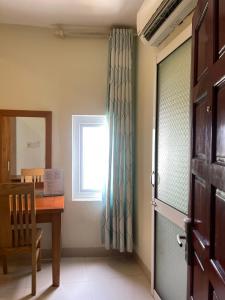 a dining room with a table and a window at Ly Ky Hotel in Quy Nhon