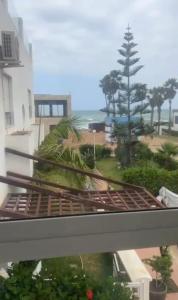 a view of the beach from the balcony of a building at المضيق in Marina Smir