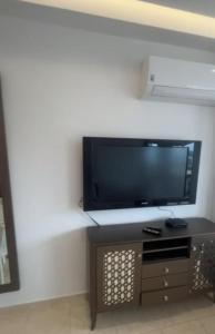 a living room with a flat screen tv on a wall at المضيق in Marina Smir