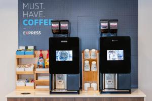 two coffee machines on a shelf in a coffee shop at Holiday Inn Express & Suites Dewitt - Syracuse by IHG in East Syracuse