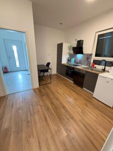 ein leerer Raum mit Küche und Holzboden in der Unterkunft Ferienzimmer No4 Ehingen in Ehingen