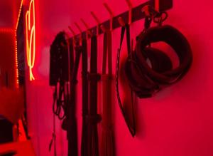 a group of umbrellas hanging on a red wall at Romantic Hot Tub Escape Discreet & Private in Tucson