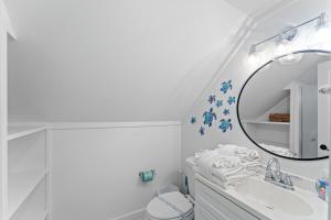 a white bathroom with a sink and a mirror at Ft Morgan Bama Belle-Beach Access in Gulf Shores +56 photos
