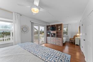 a white bedroom with a bed and a window at Ft Morgan Bama Belle-Beach Access in Gulf Shores