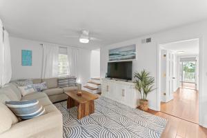 a living room with a couch and a tv at Ft Morgan Bama Belle-Beach Access in Gulf Shores