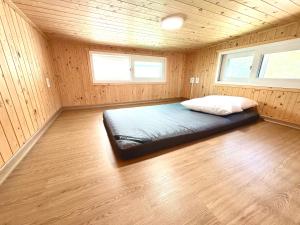 a bedroom with a bed in a wooden room at Twin Stay1 in Yonghwa