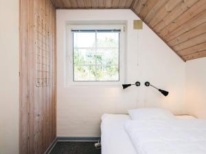 a bedroom with two beds and a window at Luxury Retreat with Pool - By Traum Ferienwohnungen in Blåvand +18 photos