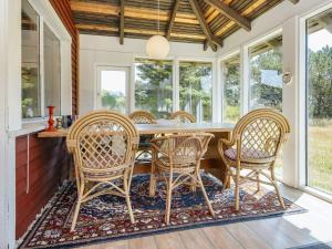 a dining room with a table and chairs at Tranquil Retreat near Beach - By Traum Ferienwohnungen in Fanø +30 photos