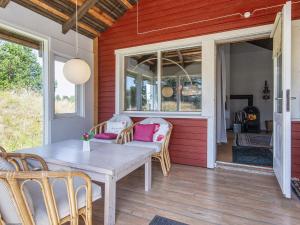 a porch with a table and chairs on a house at Tranquil Retreat near Beach - By Traum Ferienwohnungen in Fanø