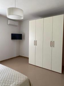 a bedroom with white cabinets and a bed at Casale Giselle in Lanciano +6 photos