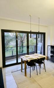a dining room with a table and some chairs at Artistic, Cozy and bright in Madinaty +27 photos
