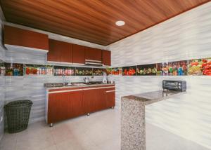 a kitchen with wooden cabinets and a counter top at Rancho Buenavista in Vergara