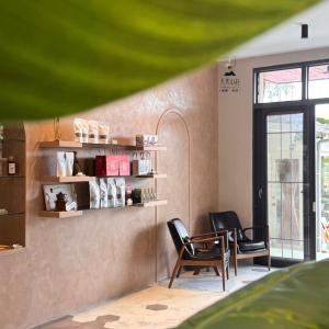 a room with two chairs and a table and a window at Tian Xiu Mountain Village in Gukeng +16 photos