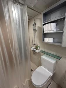 a bathroom with a toilet and a shower curtain at Seoul Station Hanok concept in Seoul
