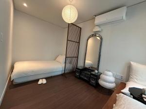 a bedroom with a mirror and a bed and a mirror at Seoul Station Hanok concept in Seoul