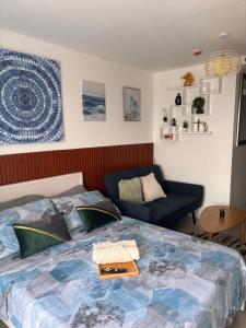 a bedroom with a large bed and a couch at Iloilo Condo Perfect for Couple in Iloilo City +18 photos