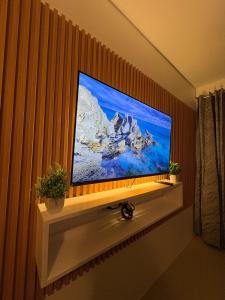 a large flat screen tv on a wall at Iloilo Condo Perfect for Couple in Iloilo City