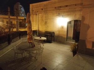 a table and chairs on a patio at night at Amaneceres in Salta