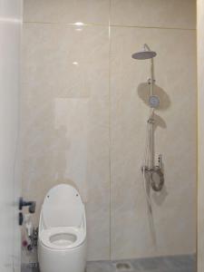 a bathroom with a toilet and a shower stall at Thatico Homestay 2 in Thôn Mỹ Phước