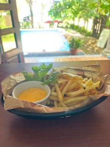 a plate of french fries and dipping sauce on a table at Hotel Rosa de los vientos in Tuxpan de Rodríguez Cano