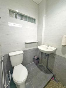 a bathroom with a toilet and a sink at Rumah Menginap in Yogyakarta +18 photos